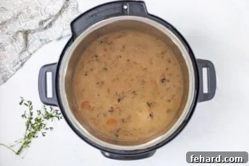 Wild rice soup inside Instant Pot after thickened with cream and cornstarch.