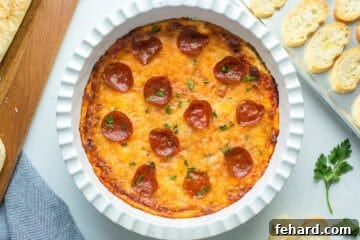 Cheesy Pizza Dip 5 Baked pizza dip in white pie plate topped with pepperoni and parsley and served with toasted crostini.