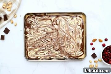 Swirled marbled bark made with dark chocolate and white chocolate on baking sheet.