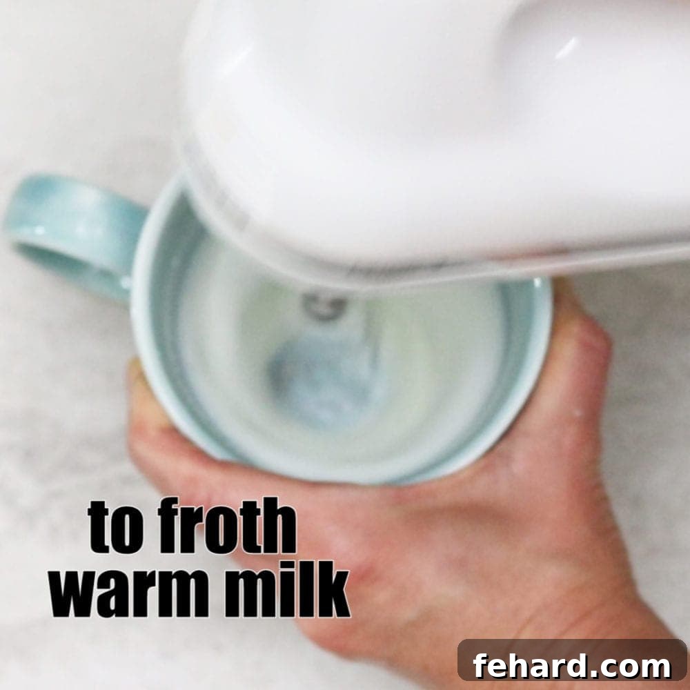 Helpful ways to use kitchen aid mixer Kitchen Mixer Frothing Milk in blue mug with text that reads to froth warm milk.