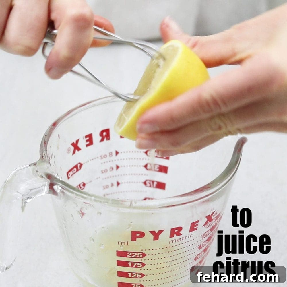 Kitchen Mixer Tricks Mixer Attachement juicing a lemon over glass with title text that reads to juice citurs