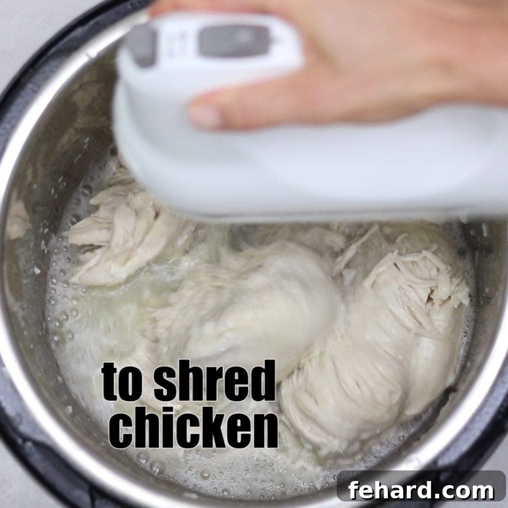 Best way to shred chicken Shredding chicken with kitchen aid mixer with text that reads to shred chicken.