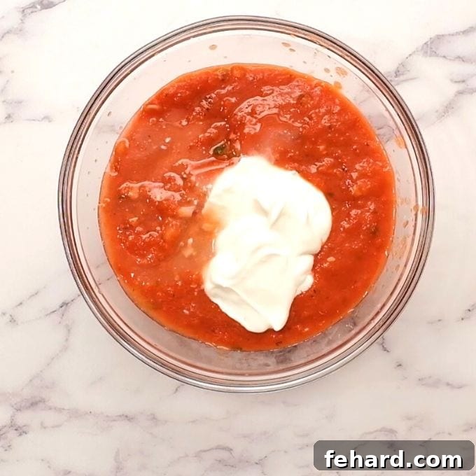 Homemade Taco Salad Dressing A small bowl holding the creamy, zesty taco salad dressing, made with salsa, sour cream, and lime juice, perfectly mixed and ready to complement the fresh ingredients.