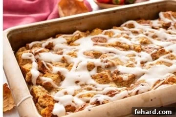 French Toast Casserole in baking dish with vanilla glaze.