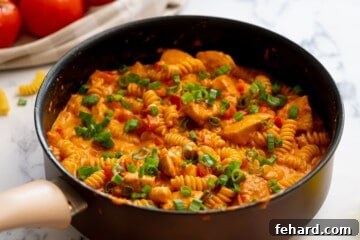 Creamy Cajun pasta with green onions ready to serve.