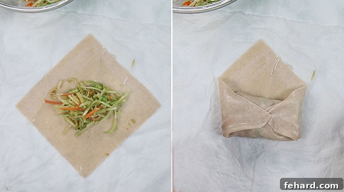 Vegan Egg Rolls Photo illustrating the process of filling an egg roll wrapper and folding the sides to begin rolling.
