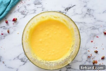 Creamed butter, sugar, eggs, and vanilla extract in large mixing bowls.