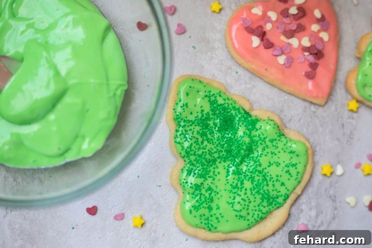 Beautifully iced heart and tree-shaped cut-out sugar cookies, decorated with festive sprinkles, showcasing perfect designs.