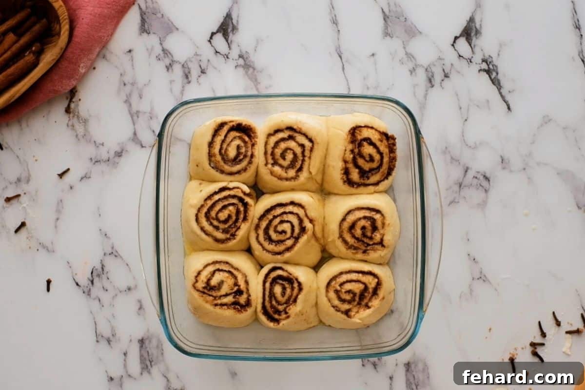 Baked Cinnamon Rolls in glass baking dish.