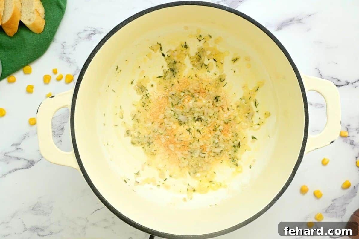 Minced shallots and fragrant thyme leaves gently sizzling in melted butter in a Dutch oven, creating an aromatic base for the chowder.