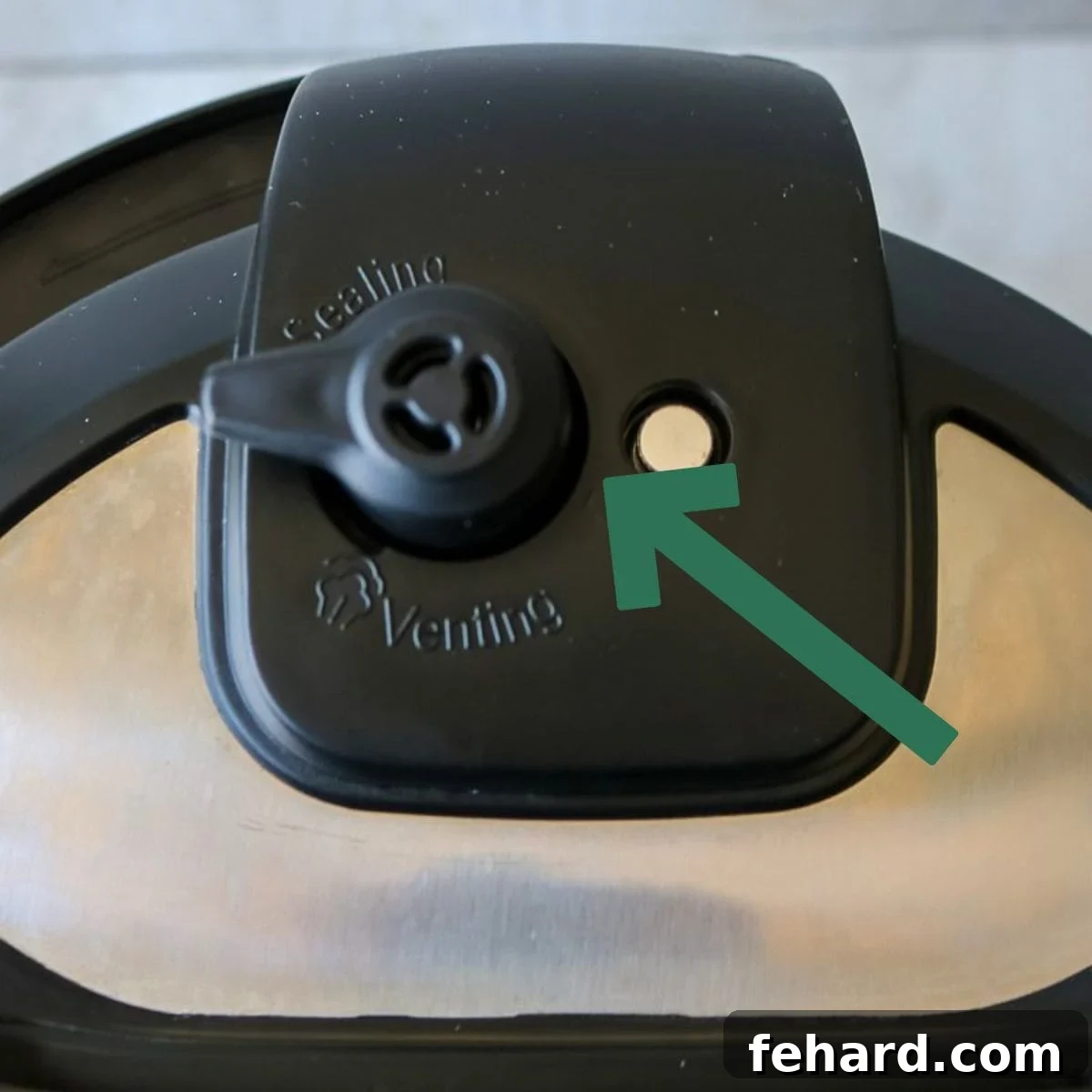 Instant Pot Lid with arrow pointing to venting knob.