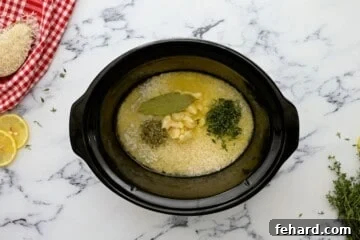 Rice, bay leaf, garlic, thyme, and Italian seasoning all combined in crockpot with chicken broth.