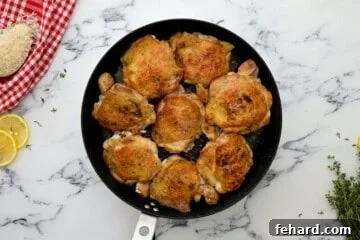 Seared chicken thighs in large saute pan.