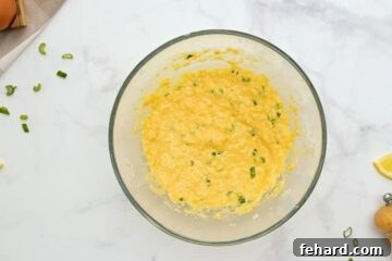 Mayonnaise mixture with green onions and lemon zest mixed together in large mixing bowl.