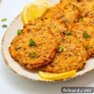 Crispy Tuna Cakes on platter with lemon wedges and green onions.