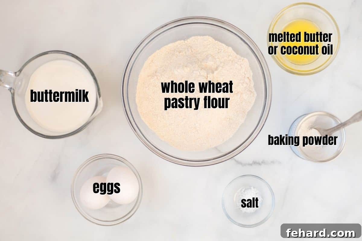 Ingredients for whole wheat pancakes laid out on a kitchen counter: flour, eggs, buttermilk, butter, salt, baking powder.