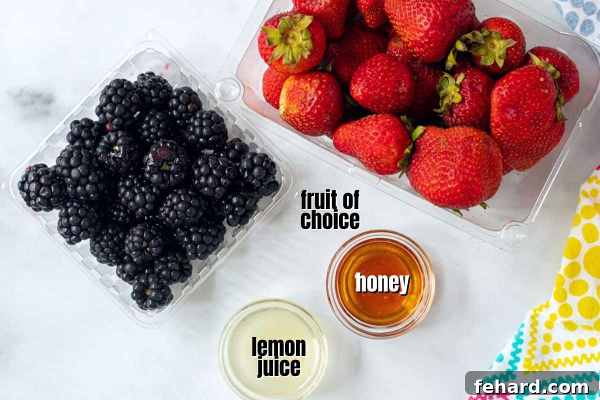 Fruit Roll Up Recipe Ingredients A carefully arranged display of fresh fruit, a bottle of maple syrup, and a lemon, illustrating the minimal and natural ingredients required for making fruit roll-ups.