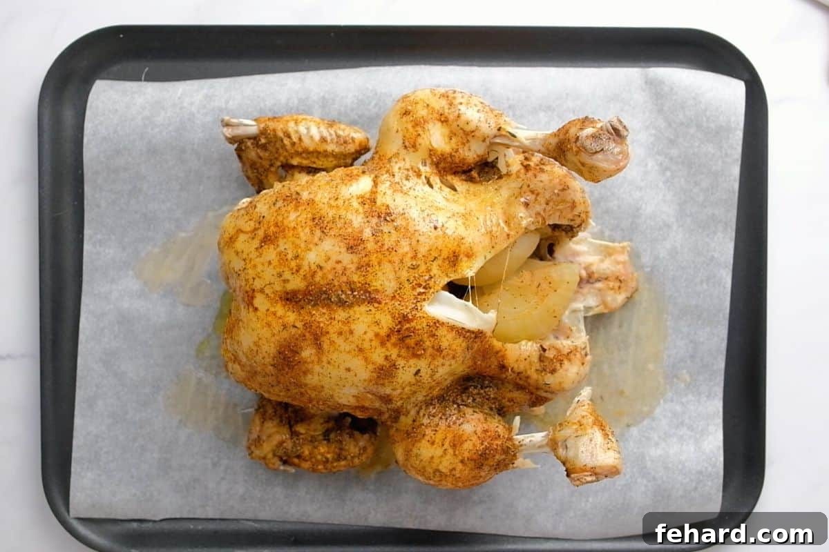 Whole Chicken on baking sheet after being broiled.