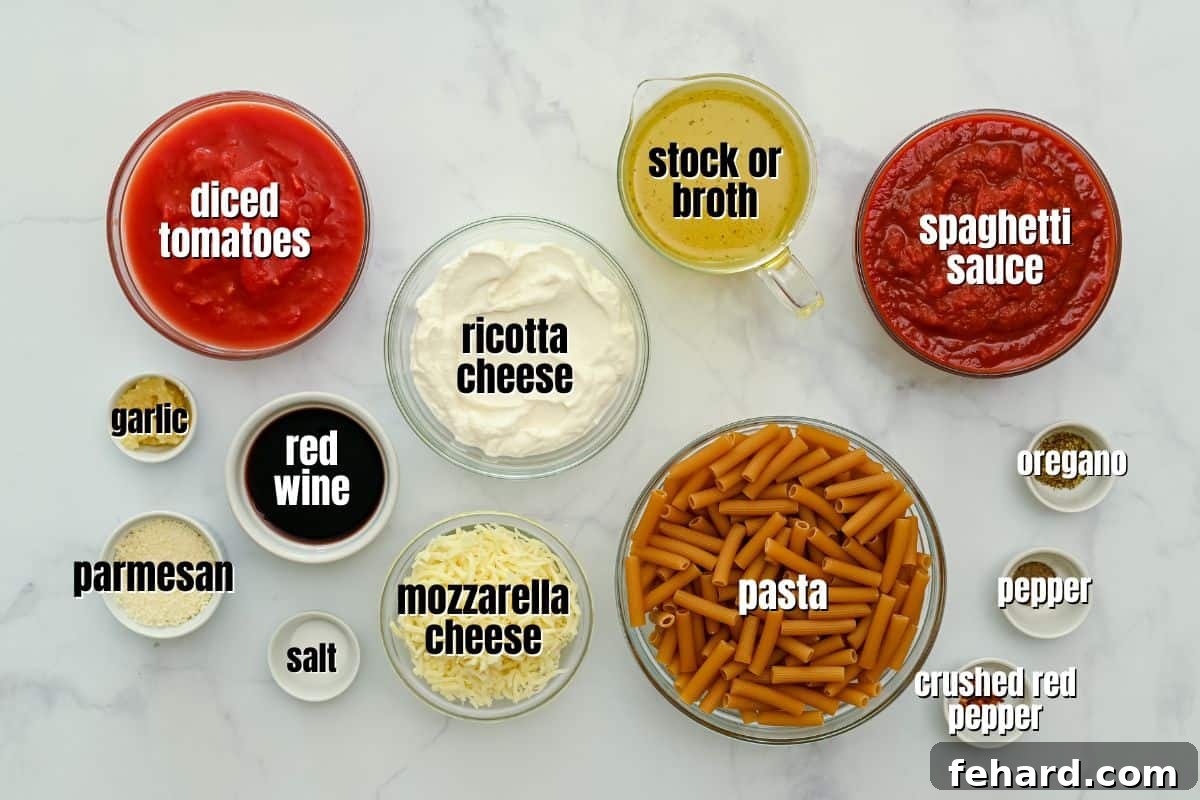 Arrangement of fresh ingredients for Instant Pot Pasta, including pasta, tomatoes, sauces, ricotta, mozzarella, and parmesan cheese on a kitchen counter.