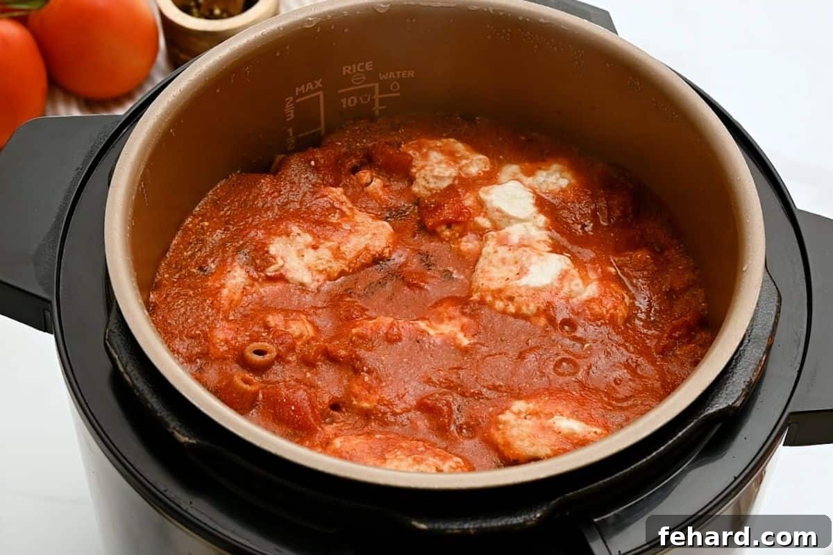 Instant Pot filled with ziti, tomato sauce, and ricotta, all perfectly pressure cooked together before being stirred.
