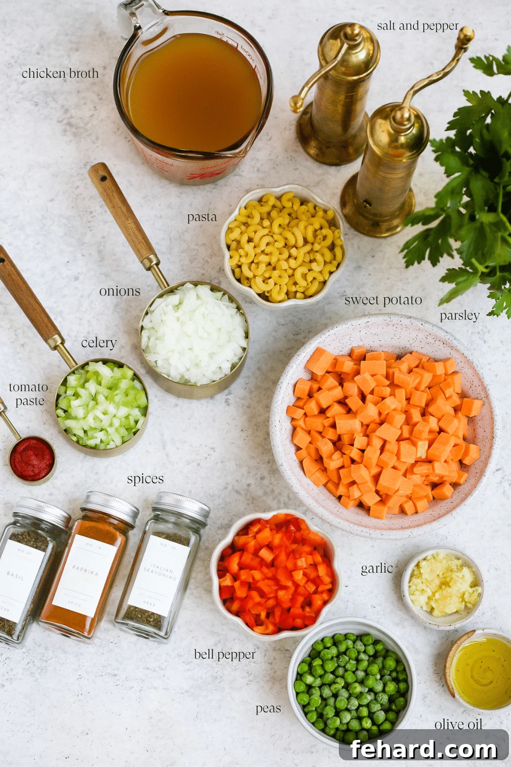 Hearty Sweet Potato and Pea Pasta Soup 3 A vibrant selection of fresh ingredients laid out for pasta soup, including sweet potatoes, bell peppers, onions, celery, garlic, and various seasonings.