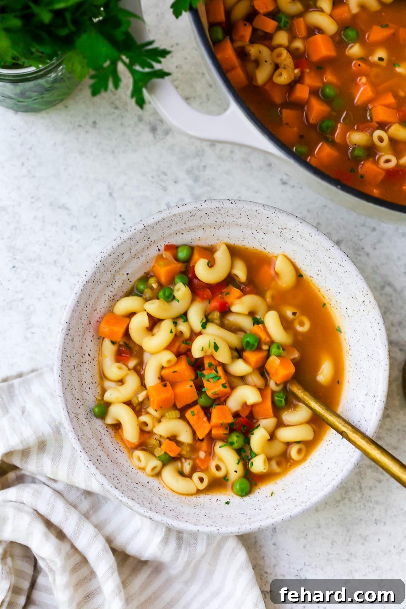 Hearty Sweet Potato and Pea Pasta Soup 7 A beautifully garnished bowl of hearty pasta soup with sweet potato and peas, ready to be enjoyed.