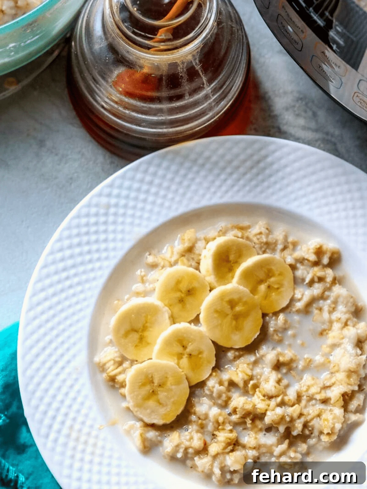 Bowl of instant pot oatmeal topped with sliced banana and honey, highlighting its creamy texture.