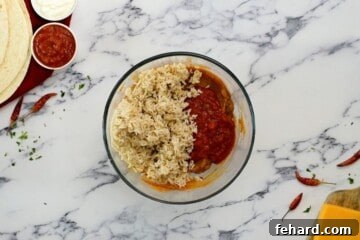 Rice and salsa added to refried bean burrito mixture.