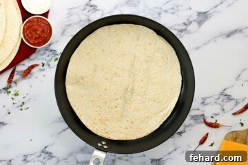 Flour tortilla warming in a dry skillet.