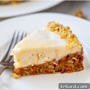 Slice of Instant Pot Carrot Cake Cheesecake slice on white plate showing layered carrot cake with creamy cheesecake.