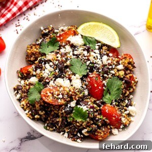 Spicy Southwest Quinoa Bowl 2 Quinoa Mexican Salad with Feta, Beans and Tomatoes in white bowl