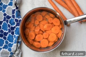 Quick & Sweet Glazed Carrots 9 Pan with carrots slices covered with water