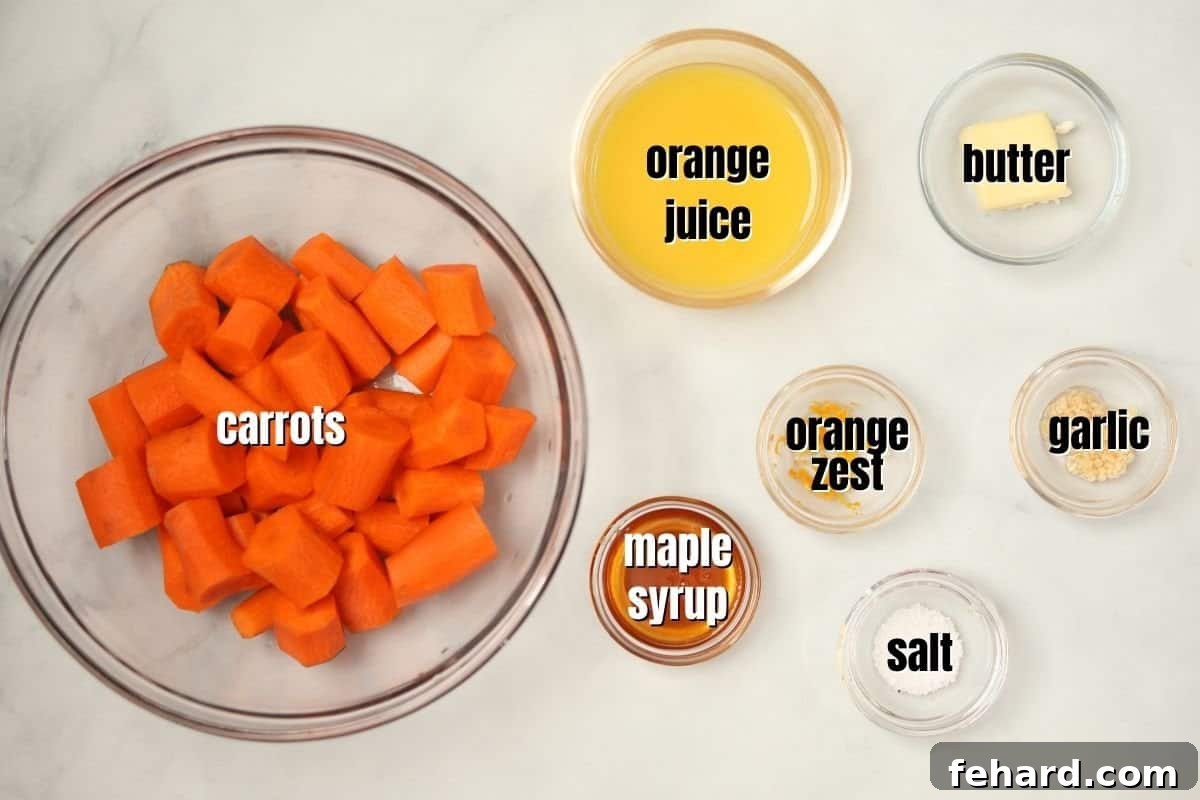 Quick & Sweet Glazed Carrots 4 A flat lay photograph showcasing all the ingredients for maple glazed carrots laid out on a kitchen counter, including carrots, maple syrup, oranges, garlic, and butter.