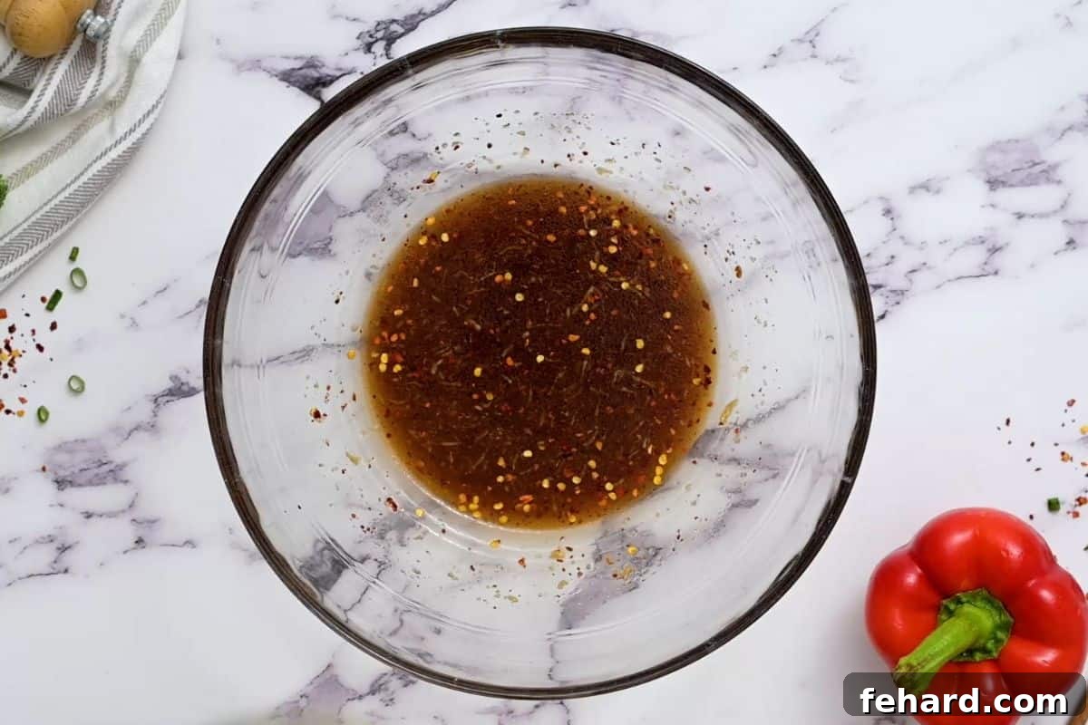 Cold Asian Noodle Salad Dressing A small bowl containing the freshly whisked sesame soy dressing, ready to be used.