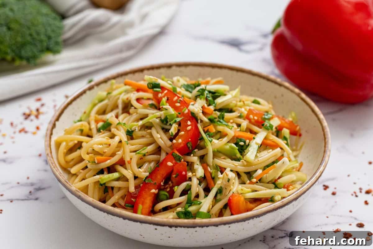 Ready to Serve Asian Noodle Salad The finished Asian Noodle Salad served in a beautiful bowl, garnished with sesame seeds, ready to eat.