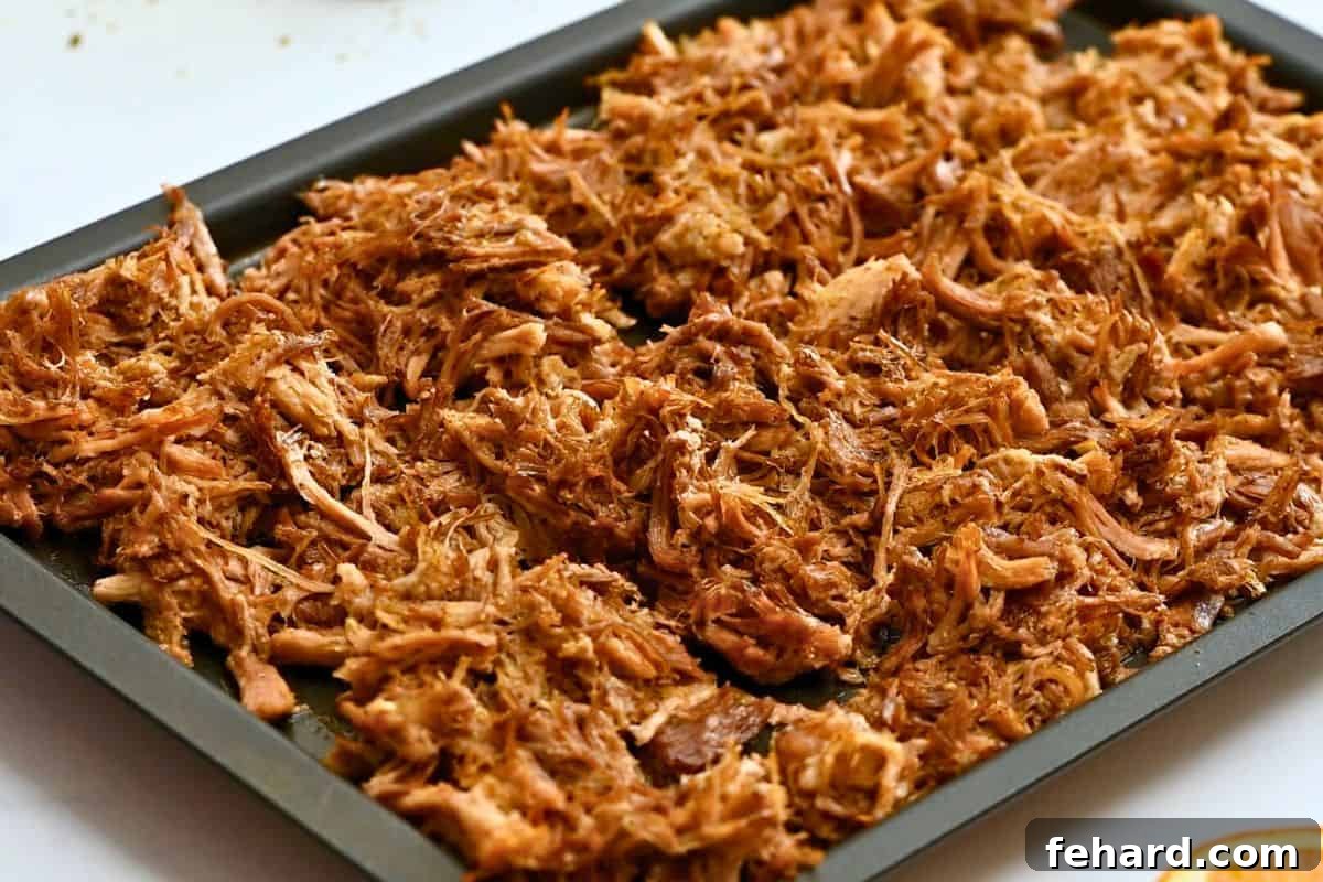 Crispy Instant Pot Carnitas Shredded pork on sheet pan after being pressure cooked and broiled to be crispy.