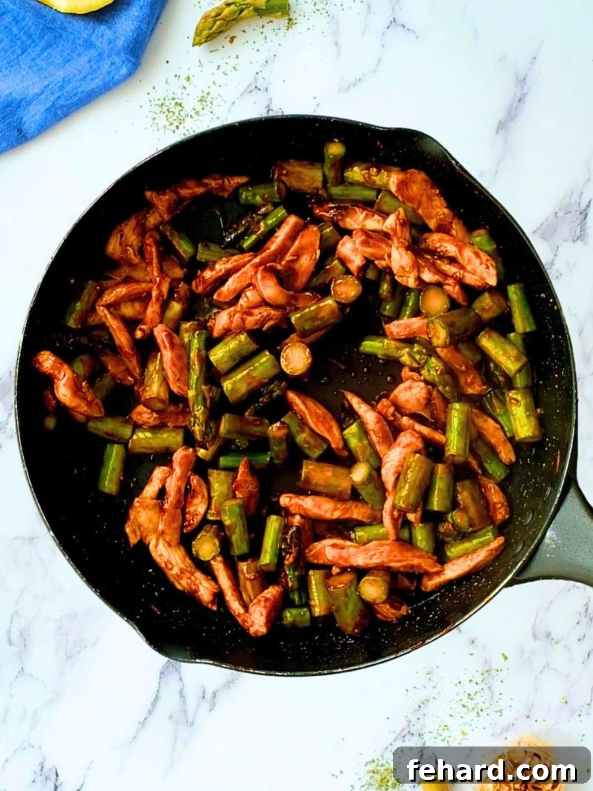 Chicken Asparagus with honey soy lemon stir fry sauce in skillet, ready to serve.