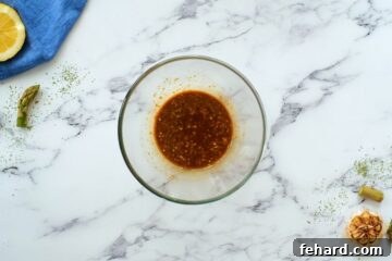 Honey lemon soy sauce in small bowl for chicken asparagus stir fry.