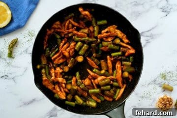 Chicken Asparagus with honey soy lemon stir fry sauce in skillet.