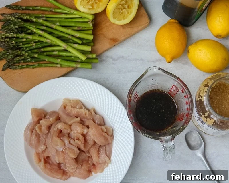 Ingredients for Lemon Chicken Asparagus Stir Fry laid out on a kitchen counter.