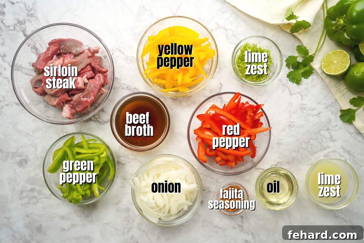 Ingredients for Steak Fajitas labeled on counter. A colorful array of fresh bell peppers, onions, steak, and lime.