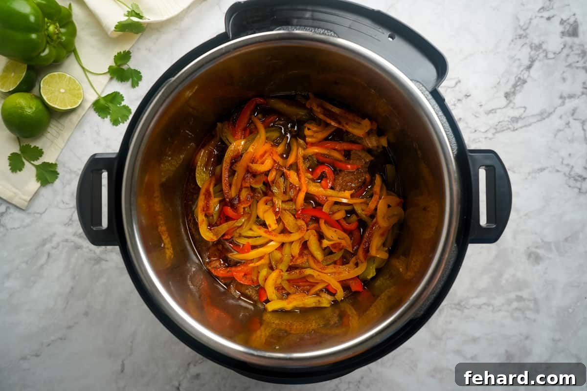 Cooked steak and pepper in instant pot. Perfectly cooked fajita mixture with tender beef and vibrant vegetables.