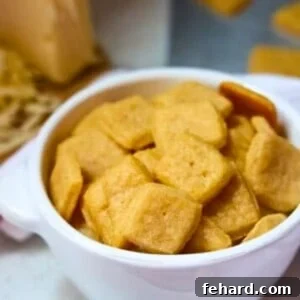 Bowl of Homemade Cheese crackers with a cheese grater in the background.