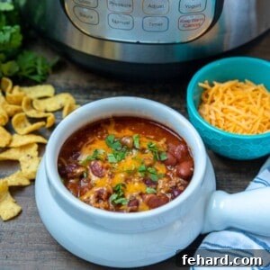 Epic Instant Pot Chili 2 Bowl of Instant Pot Beef and Bean chili next to instant pot.