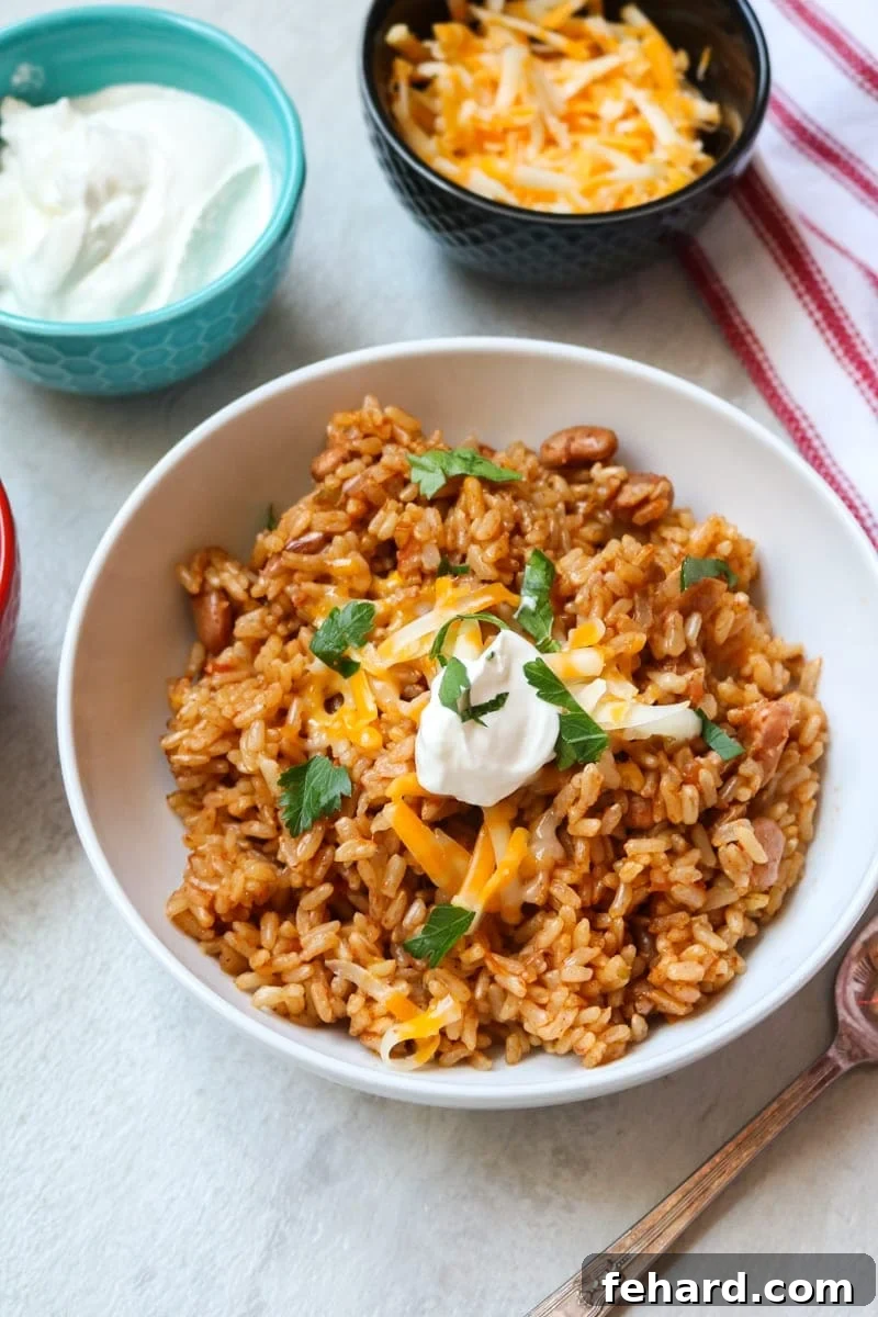 White bowl filled with Instant Pot brown rice and red beans with Mexican seasonings.