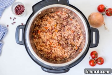 Cooked red beans and rice inside instant pot after fluffing with a fork.