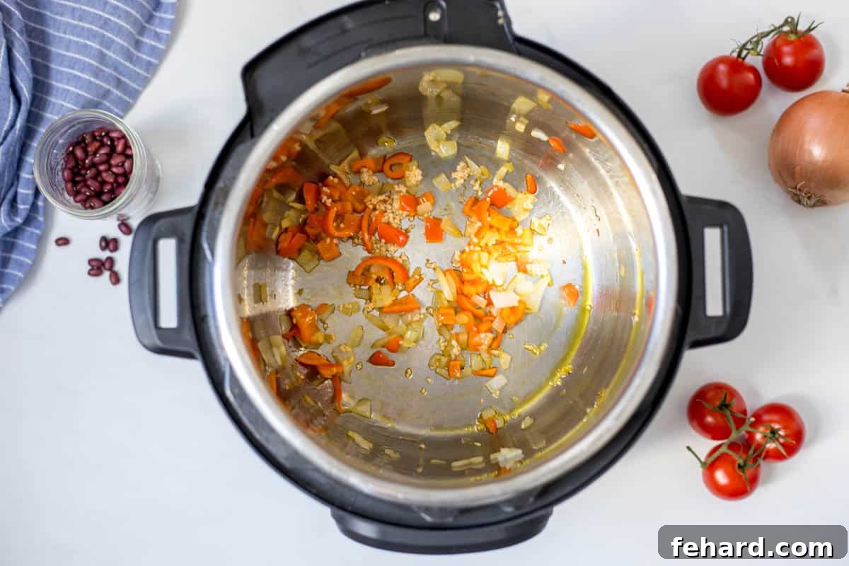 Inner pot with red pepper and onions sauteed in a bit of oil.