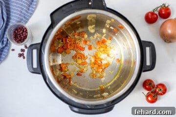 Inner pot with red pepper and onions sauteed in a bit of oil.