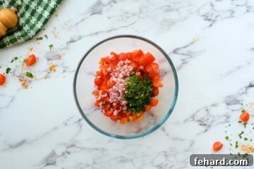 Diced tomatoes with onions and cilantro, prepared as a fresh topping.