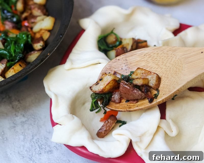 filling puff pastry with spinach, peppers and potatoes.